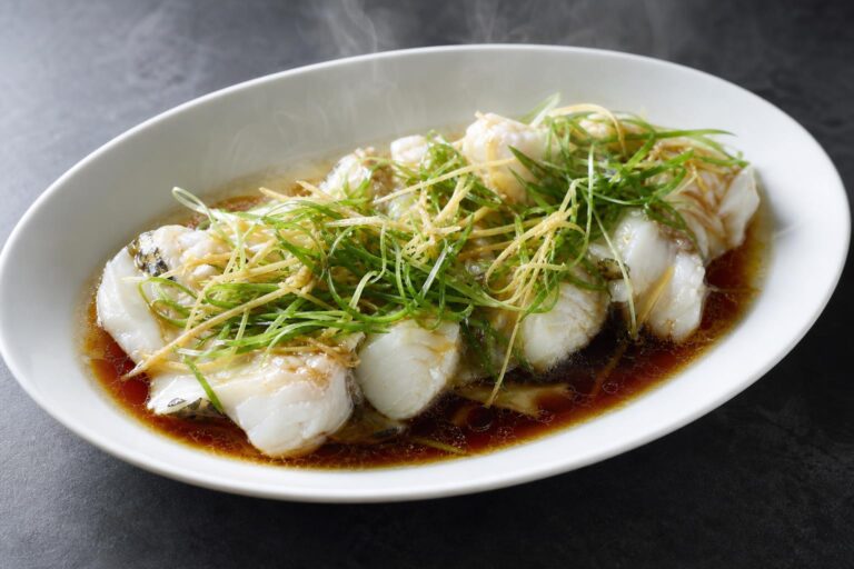 Steamed white fish fillets with ginger and scallion threads in soy sauce